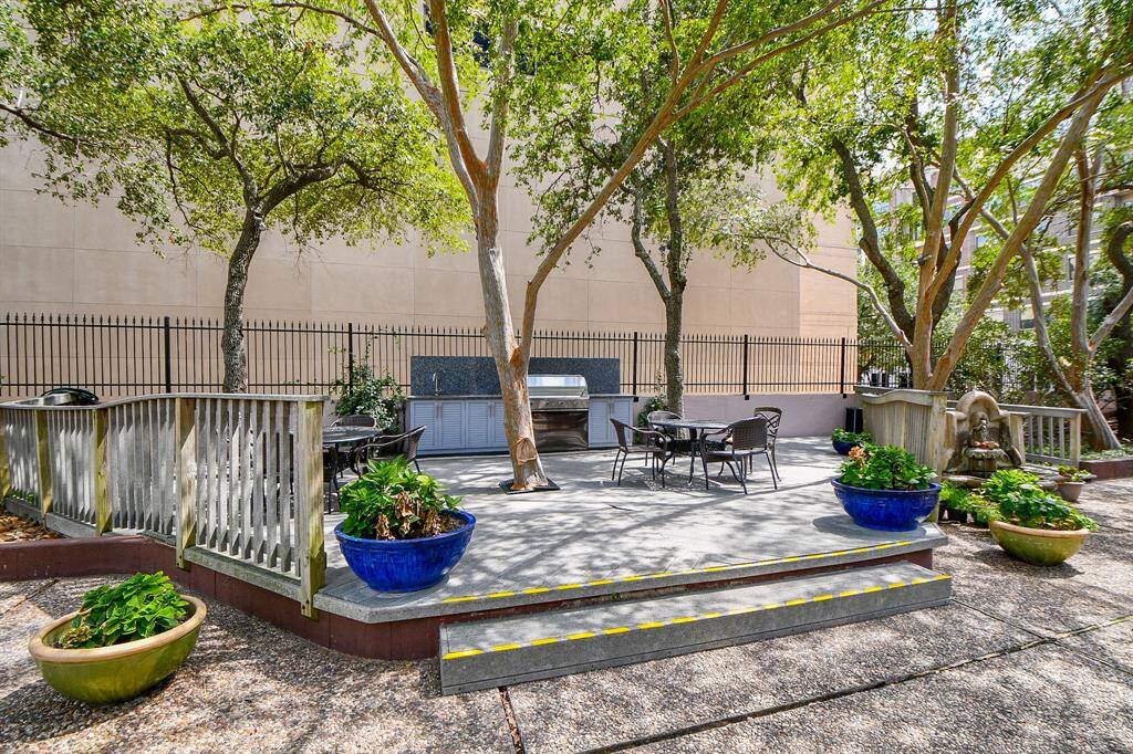 Summer kitchen grill area & courtyard just out back door of building & adjacent to pool
