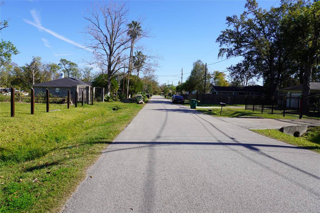 Quiet, tree-lined street offering a serene neighborhood feel, perfect for peaceful living and leisurely strolls.