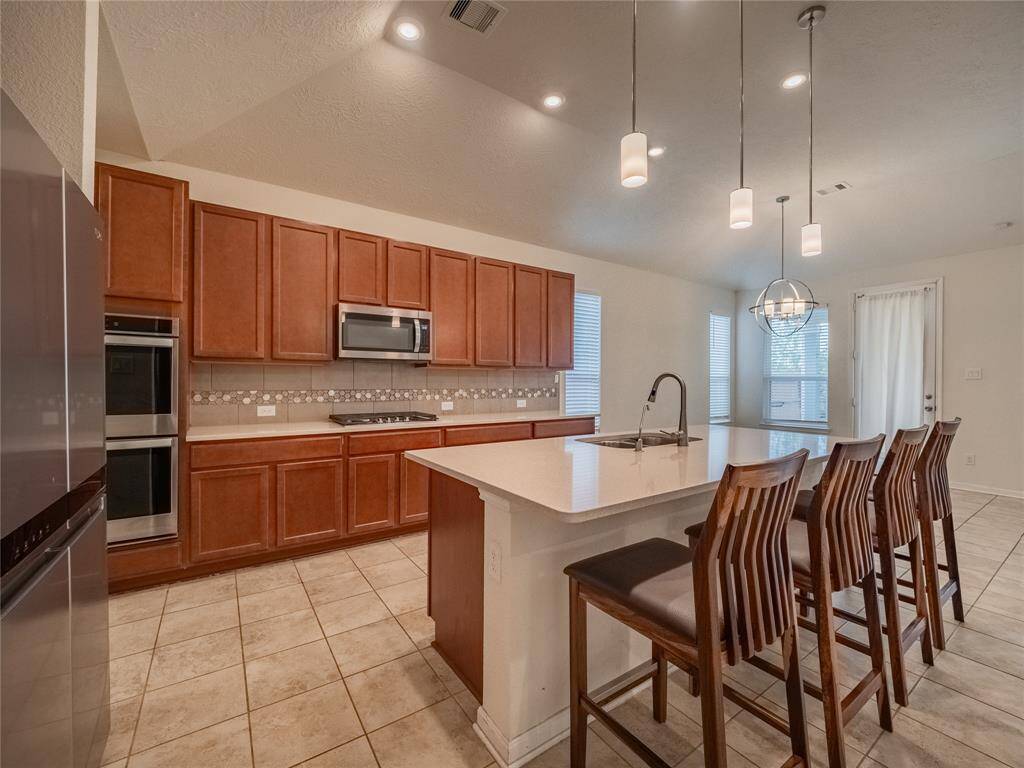 another view of the kitchen you have the double oven and the 5 burner range top , this home is perfect for a large family