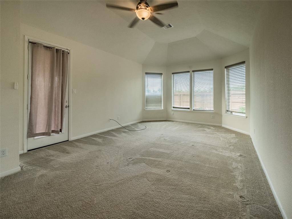 primary bedroom with a private entrance to the covered patio , bay windows