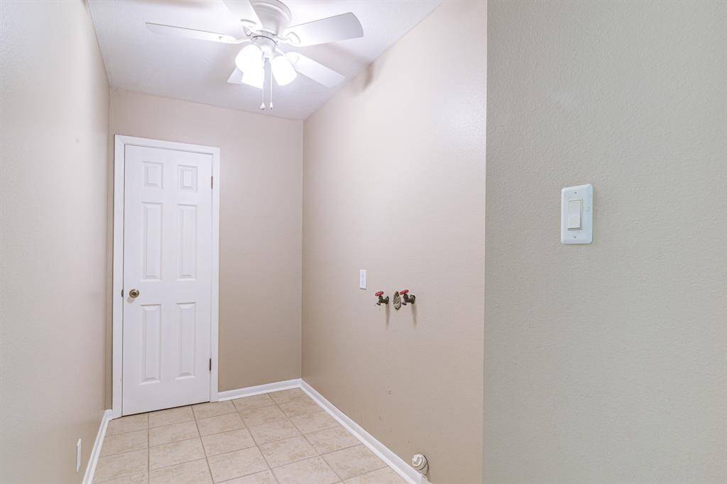 Spacious walk in laundry room with storage closet/pantry