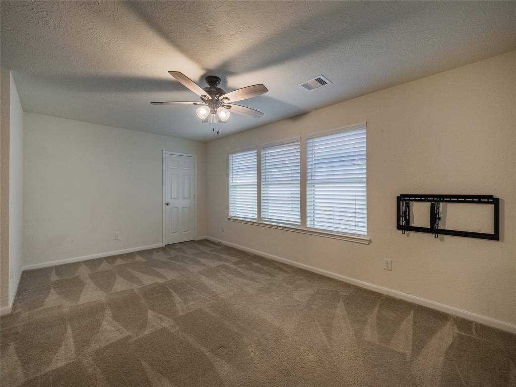 bedroom 5 upstairs with lots of windows and ceiling fan