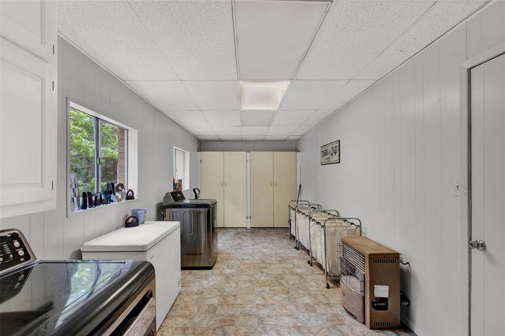 Spacious utlity room, with great added storage on back wall.