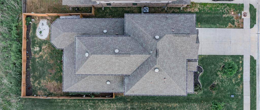 aerial view of the roof and lot and you can see the green space behind