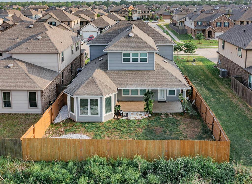 aerial view of the rear and backyard