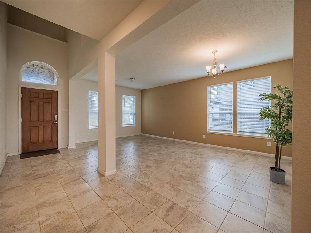 As you enter this beautiful wooden front door you have your formal living and formal dining area, all tile floor which is an upgrade