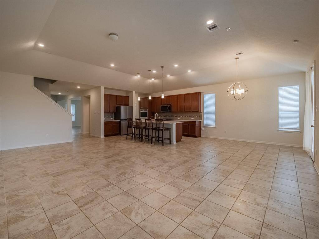 now your entering into the kitchen , breakfast nook and family area which is open floor plan very spacious lots of natural light and upgraded tile flooring