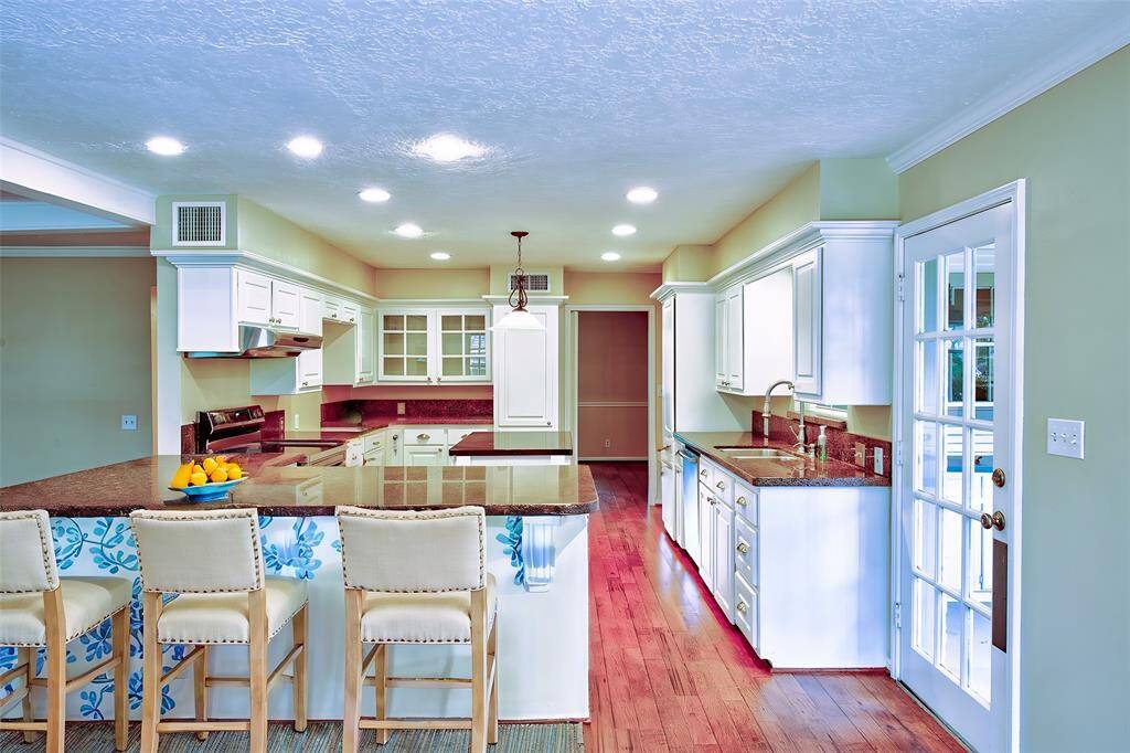 The kitchen is Virtual Staged.  The door exiting to the right leads to the car port.  The photo was taken from the breakfast area.
