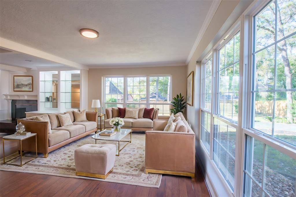 Virtual Staging of sitting area.  The living space in this home is divided into two areas.  The formal sitting area is raised above the living room.  These windows flood the area with light creating a wonderful atmosphere.