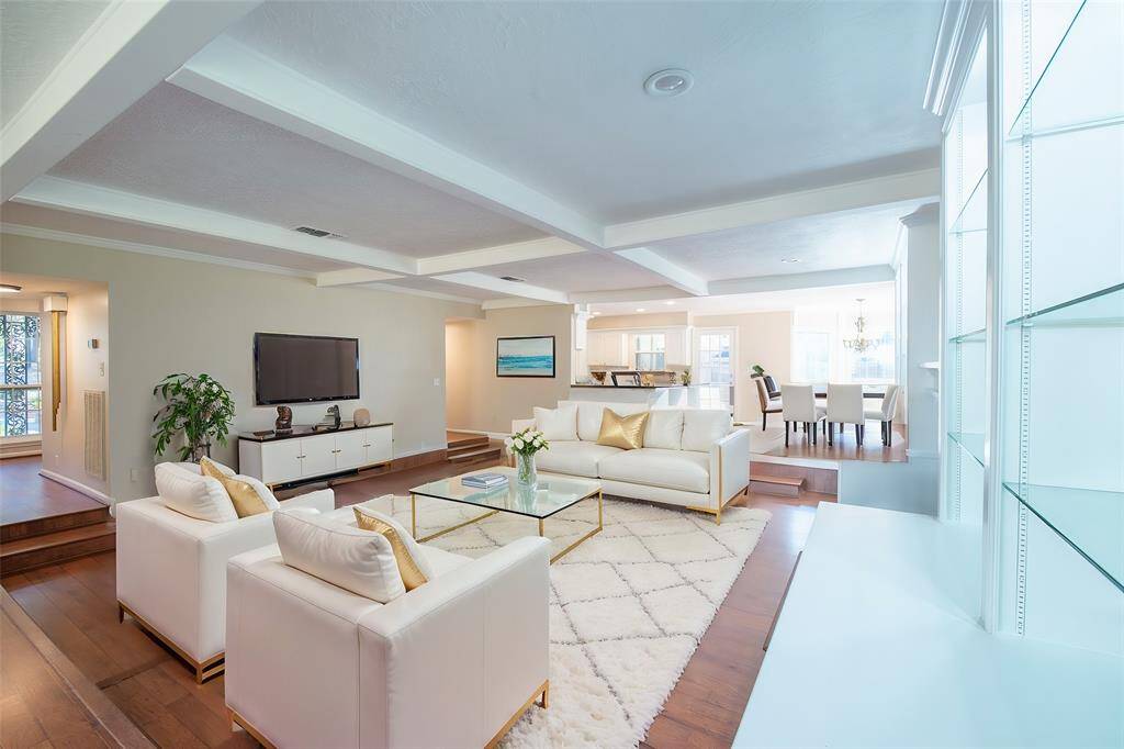 The main living area is virtually staged.  Gorgeous built-ins are to the right with a gas log fireplace to the right add beauty to the room.  You can see the breakfast in just to the right of the Kitchen.