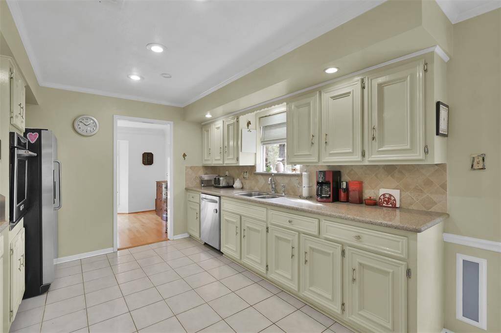 Includes stainless steel appliances and ample counter space, with a window providing natural light