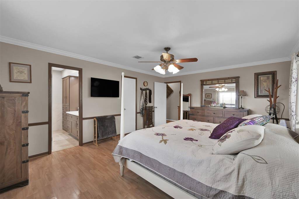 En-suite bathroom and ample natural light from windows create a warm and inviting atmosphere