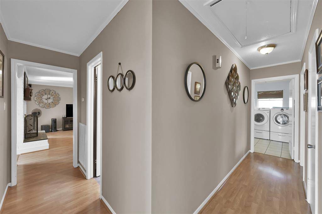 Hallway from living room leads to all bedrooms, bathroom & laundry room