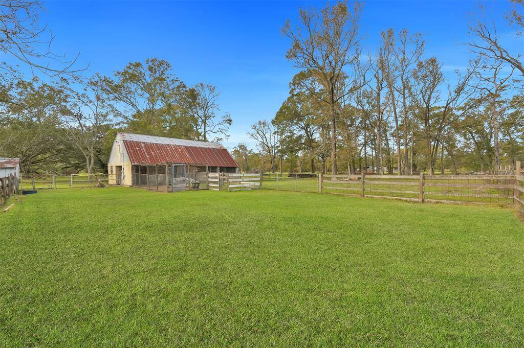 Rustic barn features 4 stalls, chicken coop, tack room & an additional story for added storage with electric & water