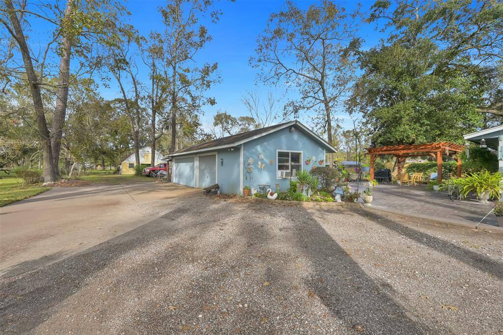 Features a 3-car garage, a welcoming driveway, and a lovely patio with a pergola, perfect for outdoor gatherings