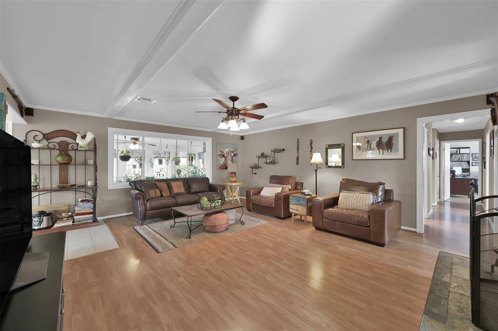 Spacious living area upon entry leads to bedrooms on the right, kitchen on the left & sunroom behind