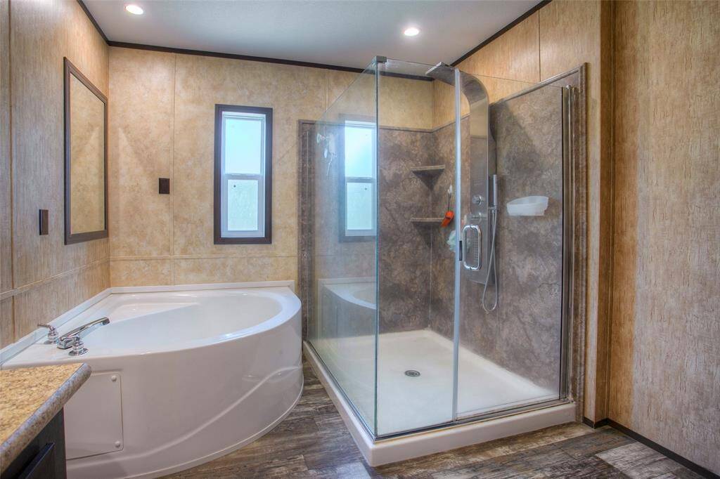 Deluxe primary bath with soaking tub and walk-in shower.