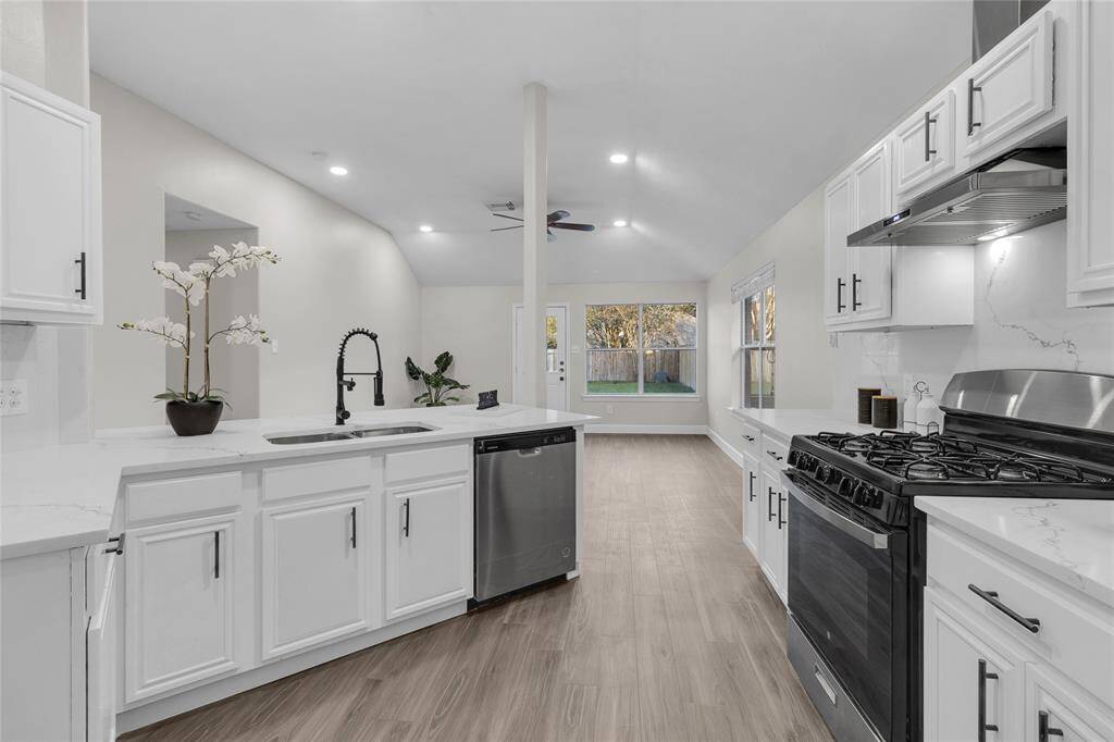 Spacious Kitchen with modern Backsplash and Quartz Countertops