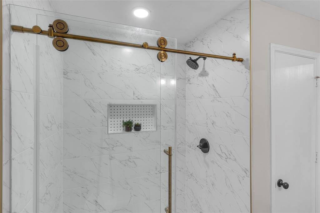 Primary Bathroom; features a spa-like glass-enclosed shower with beautiful finishings