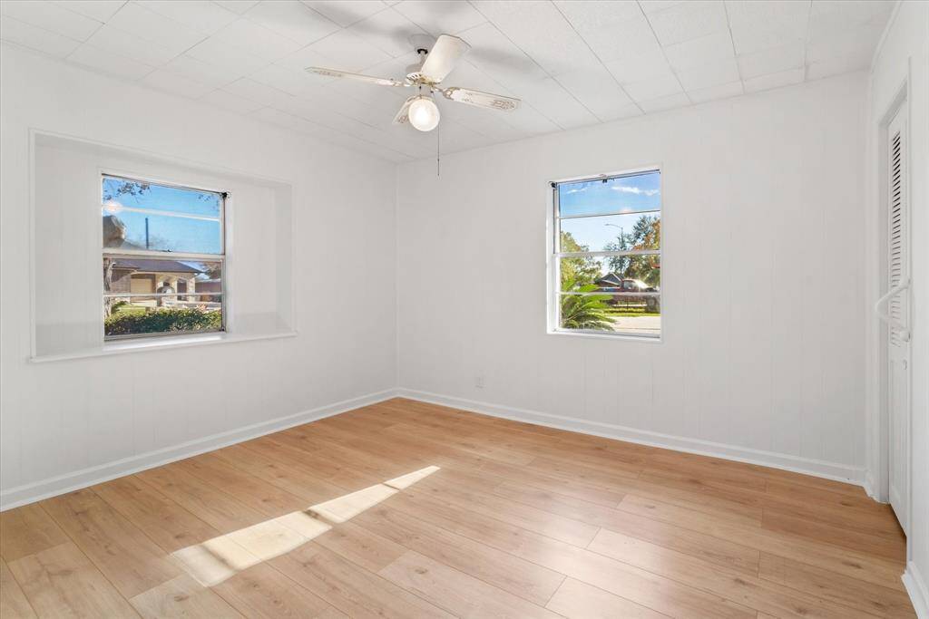 Bedroom 1 downstairs has laminate flooring, a ceiling fan, and TWO closets.