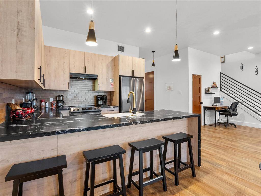 Spacious kitchen island with elegant seating, perfect for casual dining and entertaining.