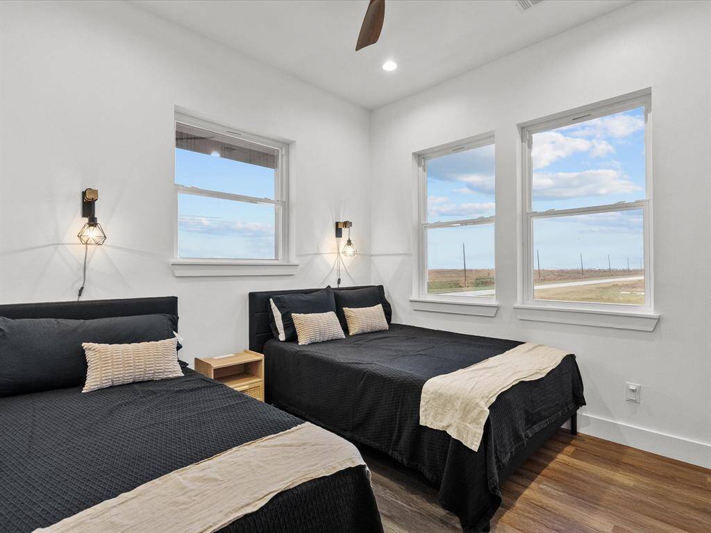 Bright bedroom immediately to the left upon entry, featuring large windows with scenic views.