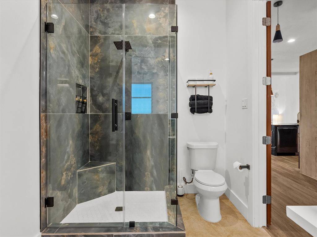 Access the bathroom conveniently from either the bedroom or hallway.