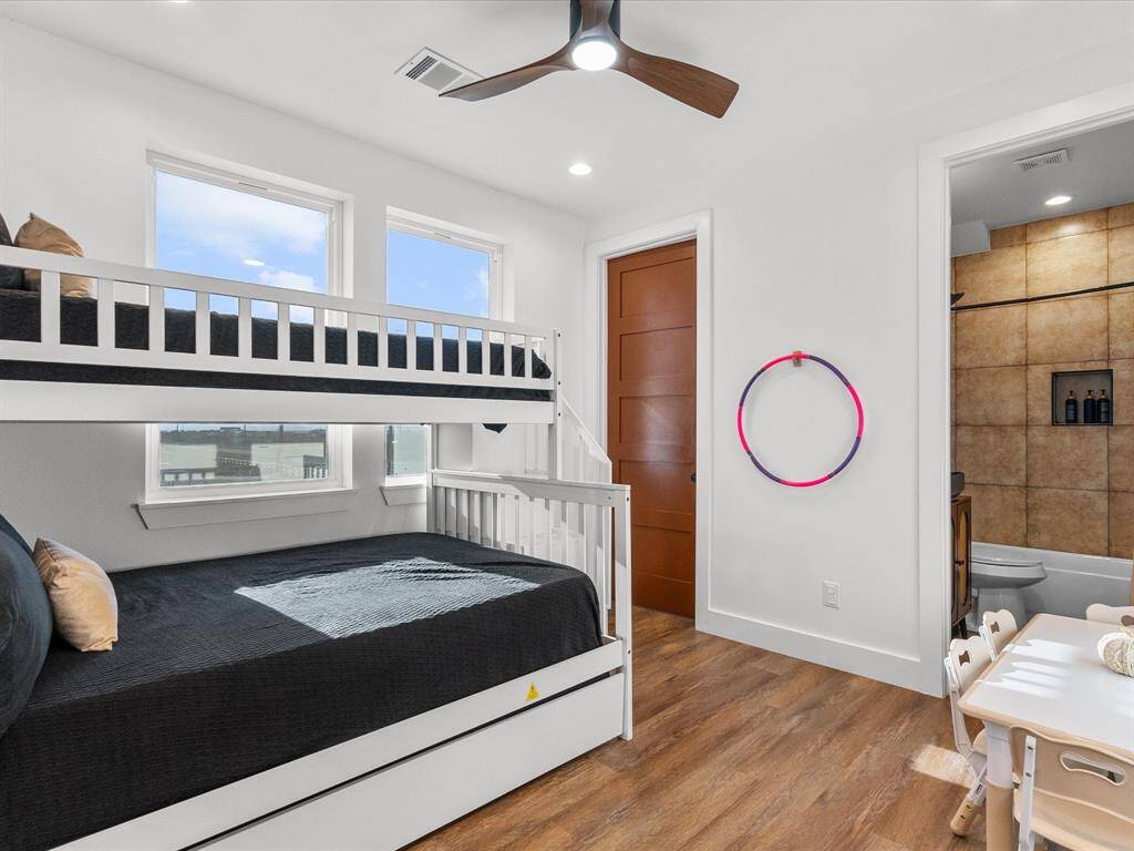 Bright and inviting bunk room with modern finishes, perfect for accommodating guests or creating a cozy retreat for kids.