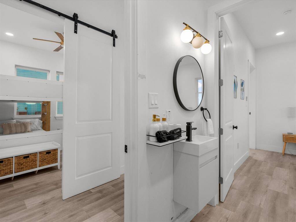Modern bathroom featuring sleek fixtures, elegant lighting, and a space-saving vanity.