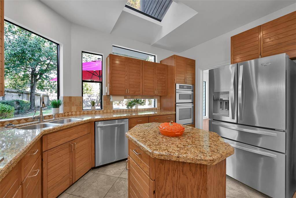 Custom cabinetry with top of the line stainless steel appliances.  Just look at those beautiful windows and two skylights.
