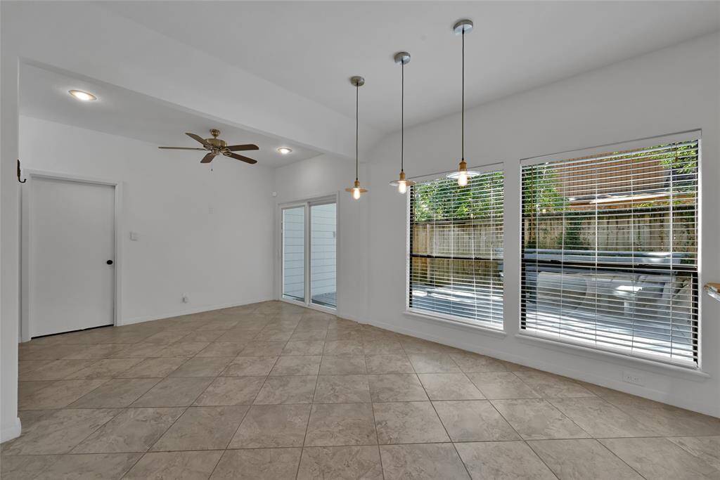 View of the breakfast room leading outside to a secluded shaded patio.