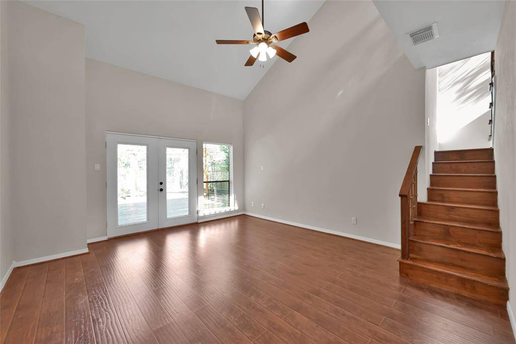 Another view of the primary suite, offering natural light, and access to upstairs private room and outside patio.