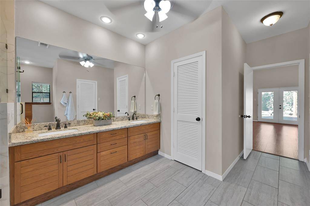 His and her sinks as well as his and her closets with linen closet make this the perfect primary retreat.