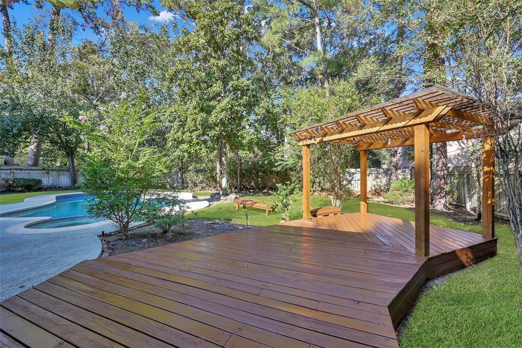Step outside from the primary suite onto a freshly stained balcony and pergola.  Outdoor lights have already been hung offering a nighttime glowing ambiance.