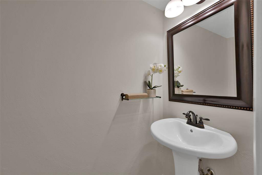 First floor powder room, adjacent to the laundry room.  It's near the kitchen and steps from the dining room.
