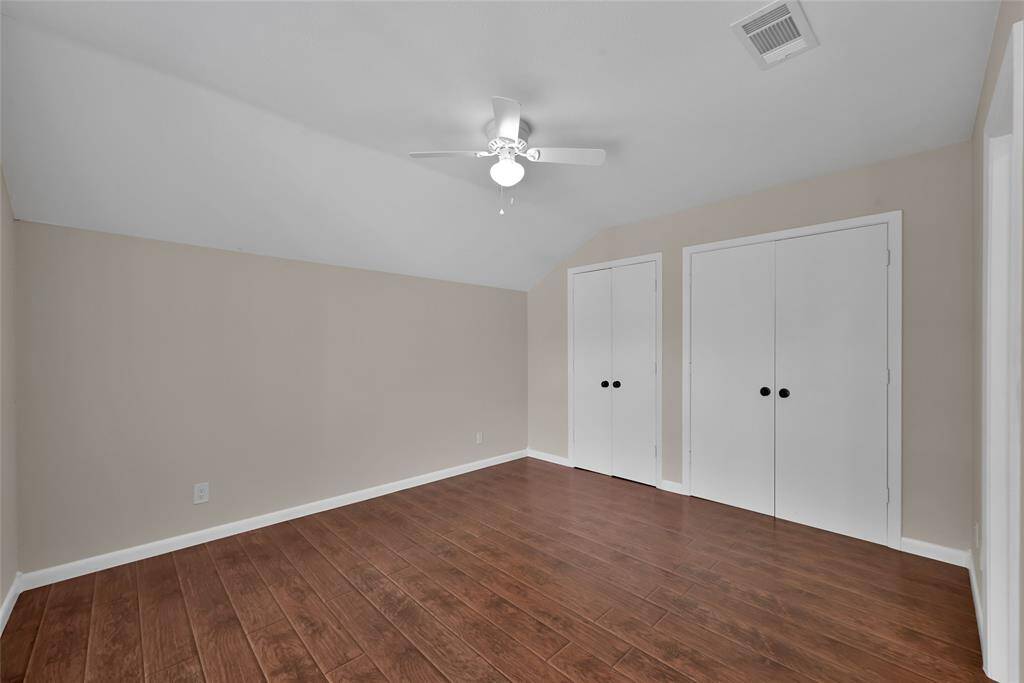 Front secondary bedroom offers double closets and access to the attic with lots of storage.