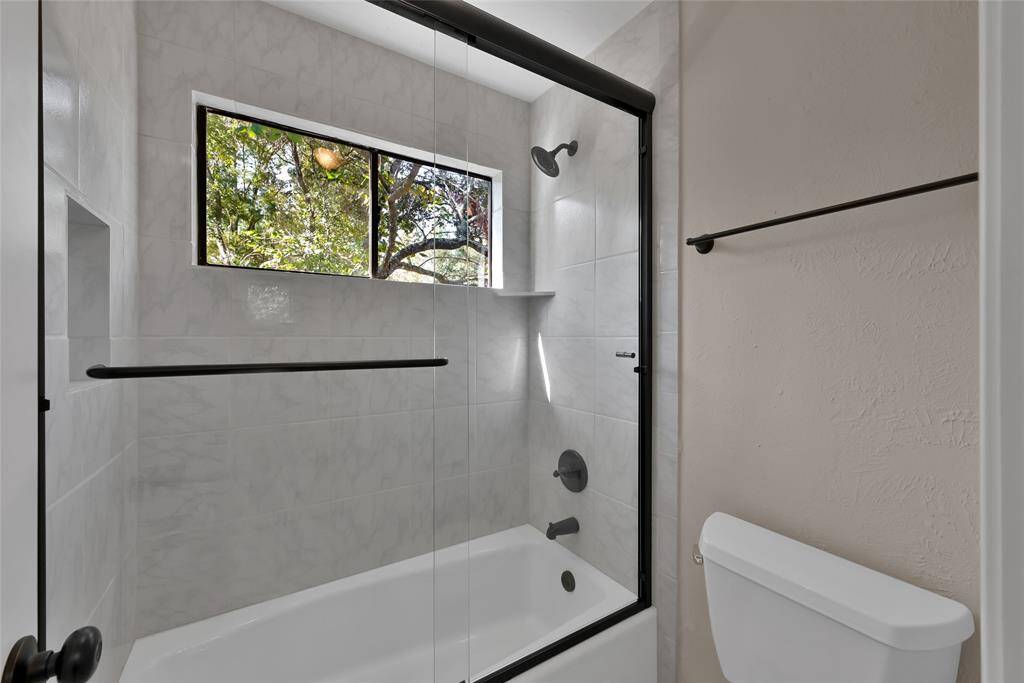Completely updated bathrooms with glass shower doors and fixtures.