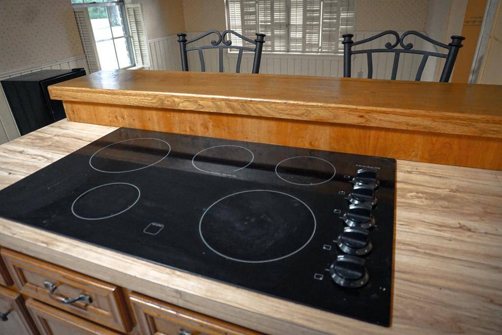 Electric stove inside the island with bar stool for serving!
