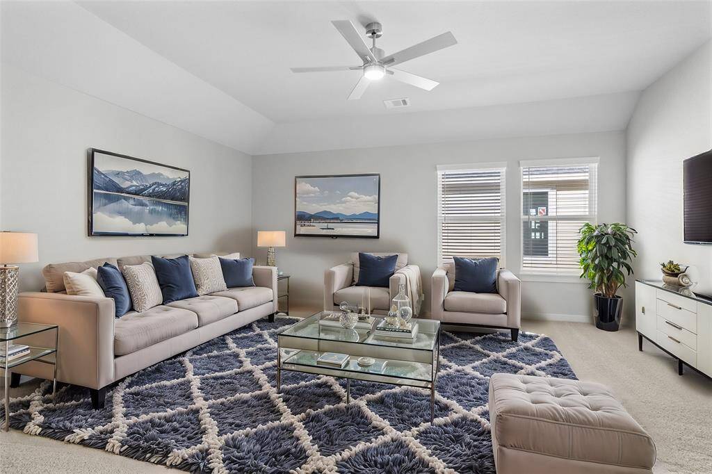 This spacious and bright game room features custom paint with gorgeous plush carpet, ceiling fan and large windows with privacy blinds! With the ample amount of space provided, you can turn this area into anything! From a media room to a children's play room, the possibilities are endless!