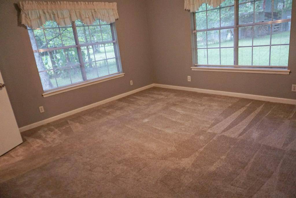 Primary bedroom with beautiful views of the backyard.