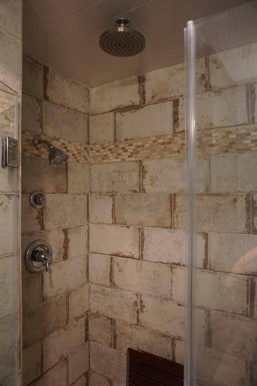 Custom shower with spa like experience, 2 shower heads, and a bench installed.