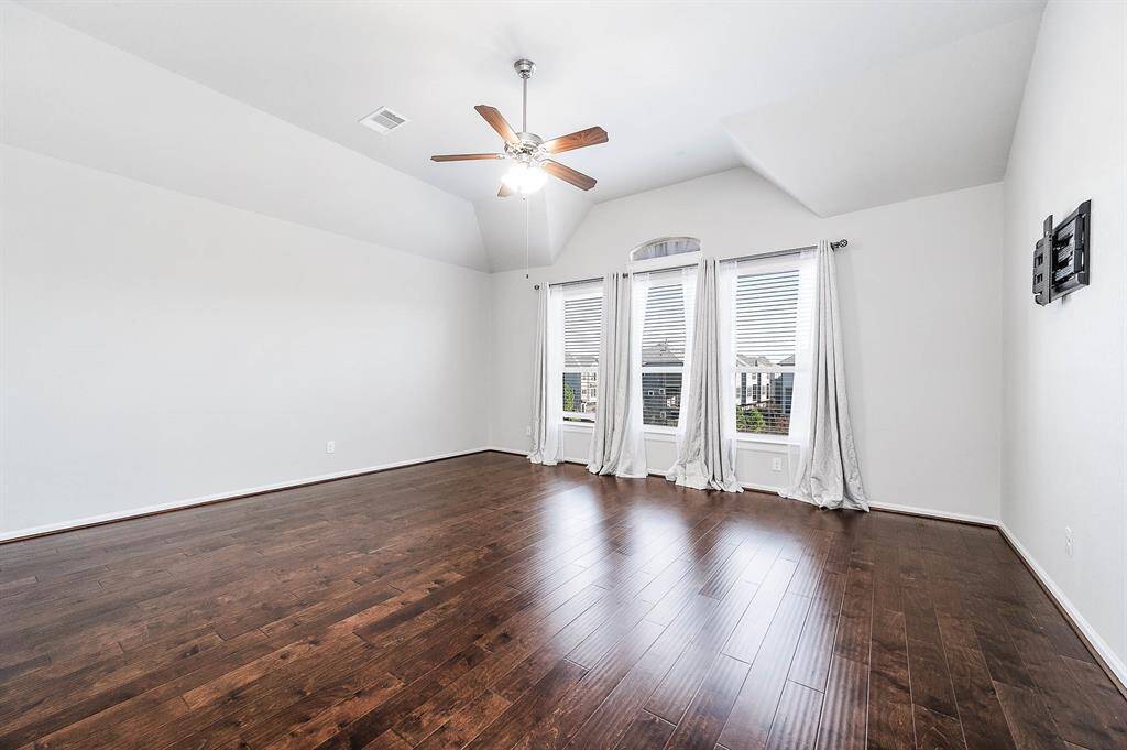 You will have to come see how big this primary is in person! Vaulted ceiling with fan and a beautiful view of the neighborhood from back of home. TV mount included for convenience.