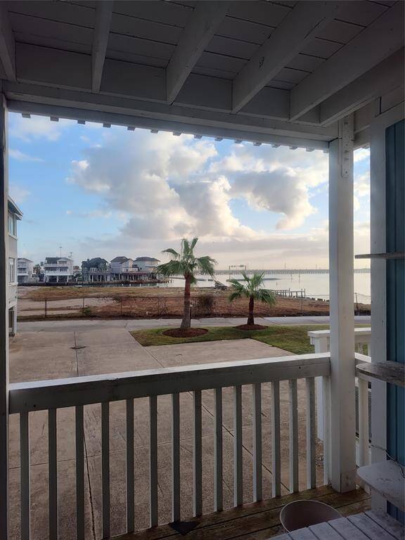 View from inside house looking out over deck.