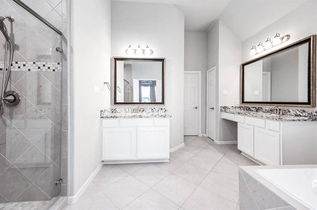Primary bath includes separate dual vanities, linen closet and toilet room, stand alone tub and separate shower.