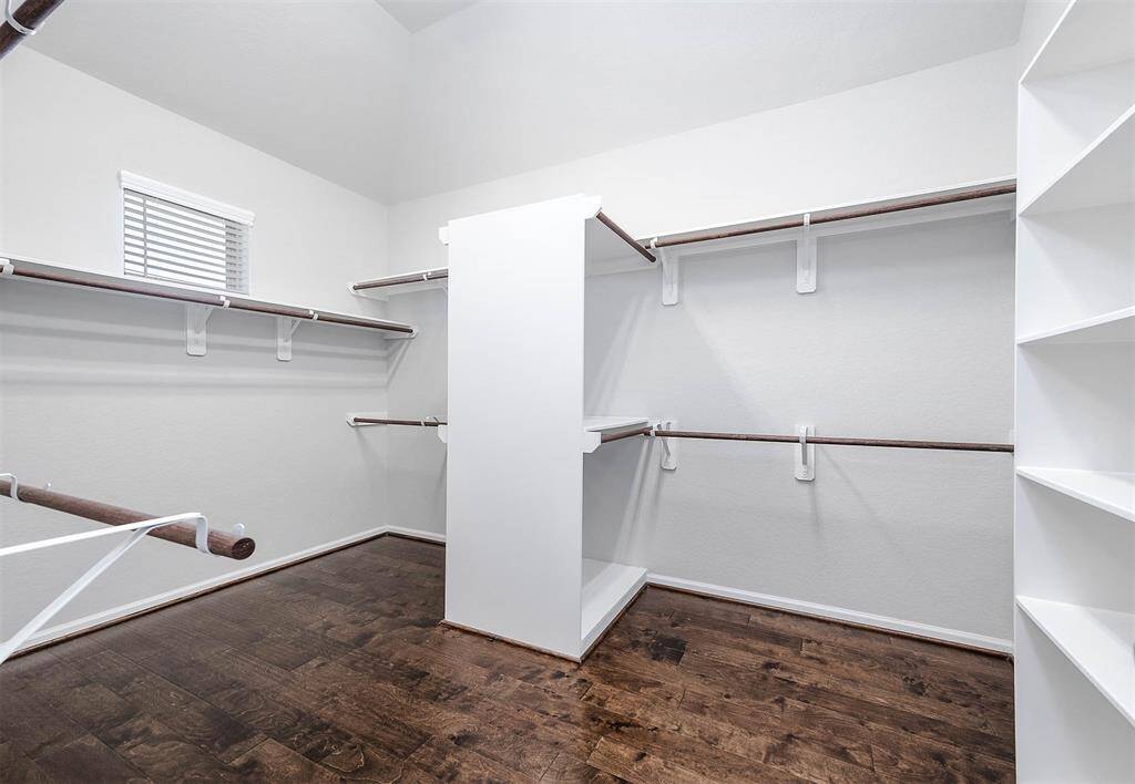 Extra large primary bedroomm walk-in closet with built-ins.