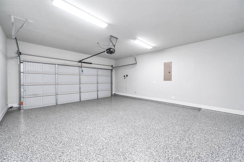 2 car garage with epoxy flooring and 220V EV charging outlet on back wall (not pictured).