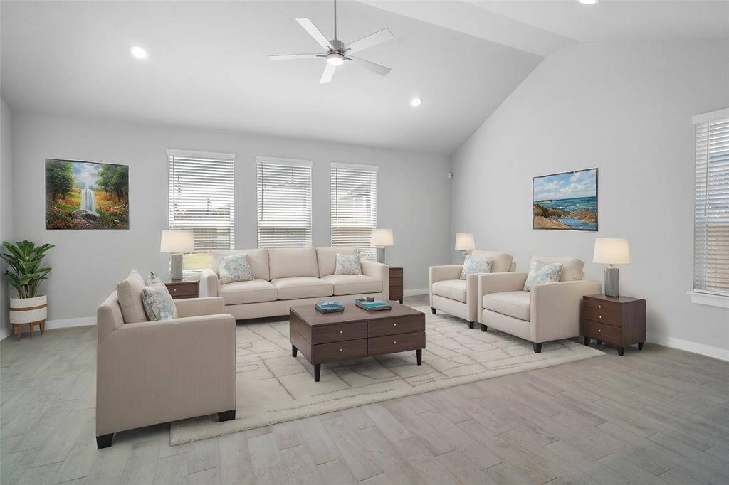 Quietly nestled in front of the home is the handsome home office. Featuring wood look tile flooring, high ceilings with ceiling fan, large windows with privacy blinds and custom paint.