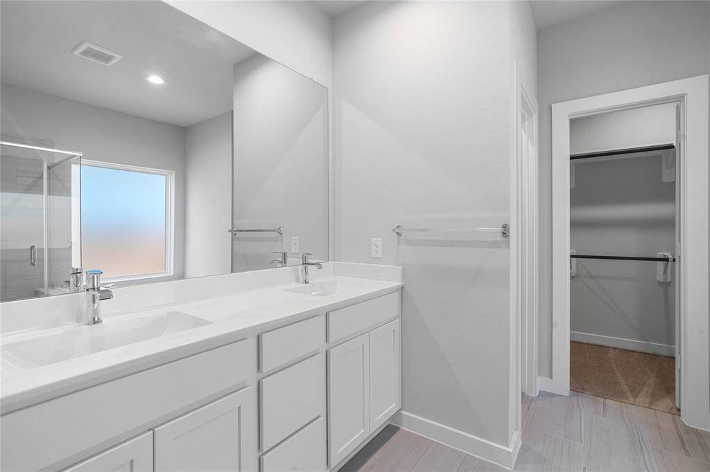 This kitchen is by far any chef’s dream! This spacious kitchen features high ceilings, stained wood cabinets, quartz countertops, SS appliances, modern tile backsplash, recessed lighting, extended counter space for breakfast bar, and pantry all overlooking your huge family room.