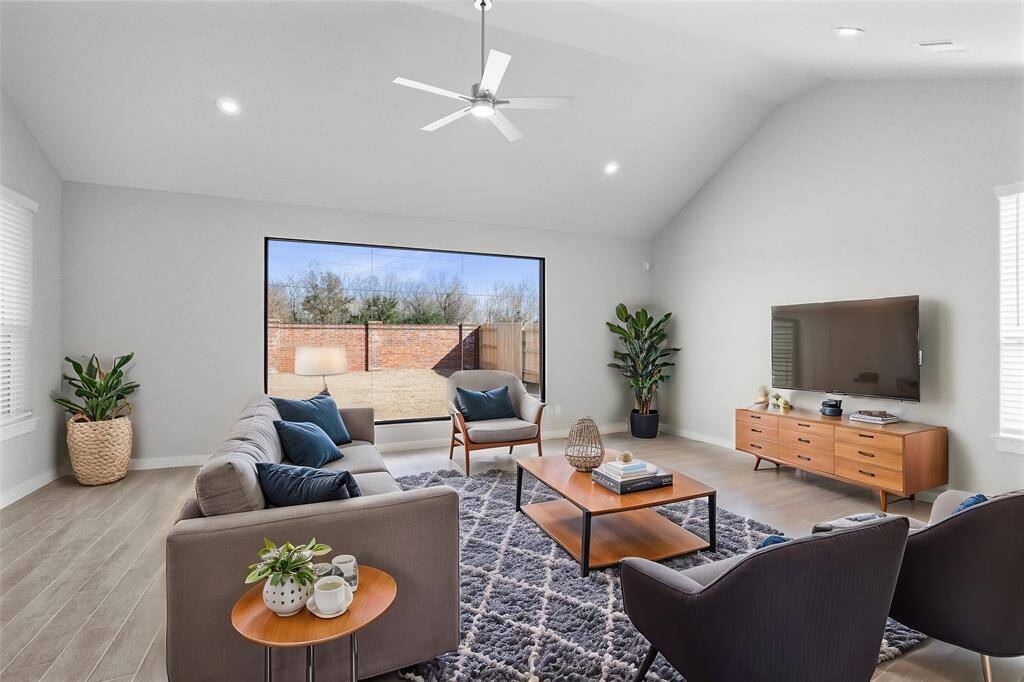 Gather the family and guests together in your lovely family room! Featuring high ceilings with ceiling fan, recessed lighting, custom paint, gorgeous wood look tile floors and a large picture window that provides plenty of natural lighting throughout the day.