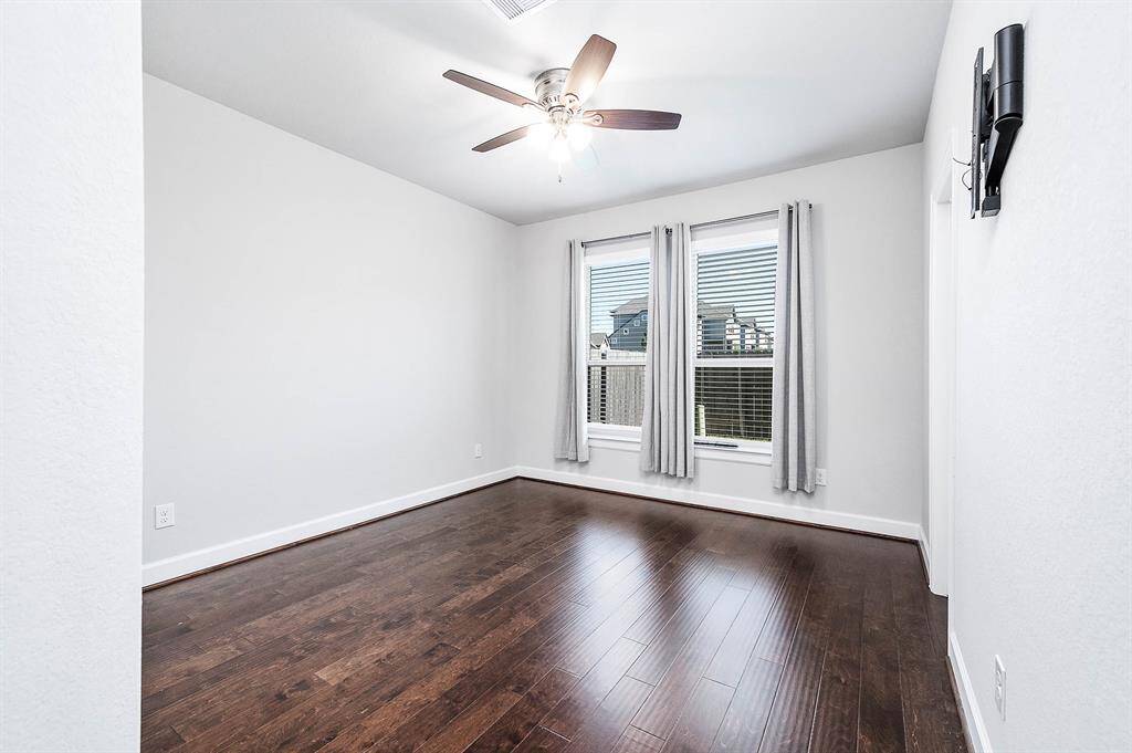 3rd bedroom on 1st floor with ceiling fan. TV mount included for convenience.